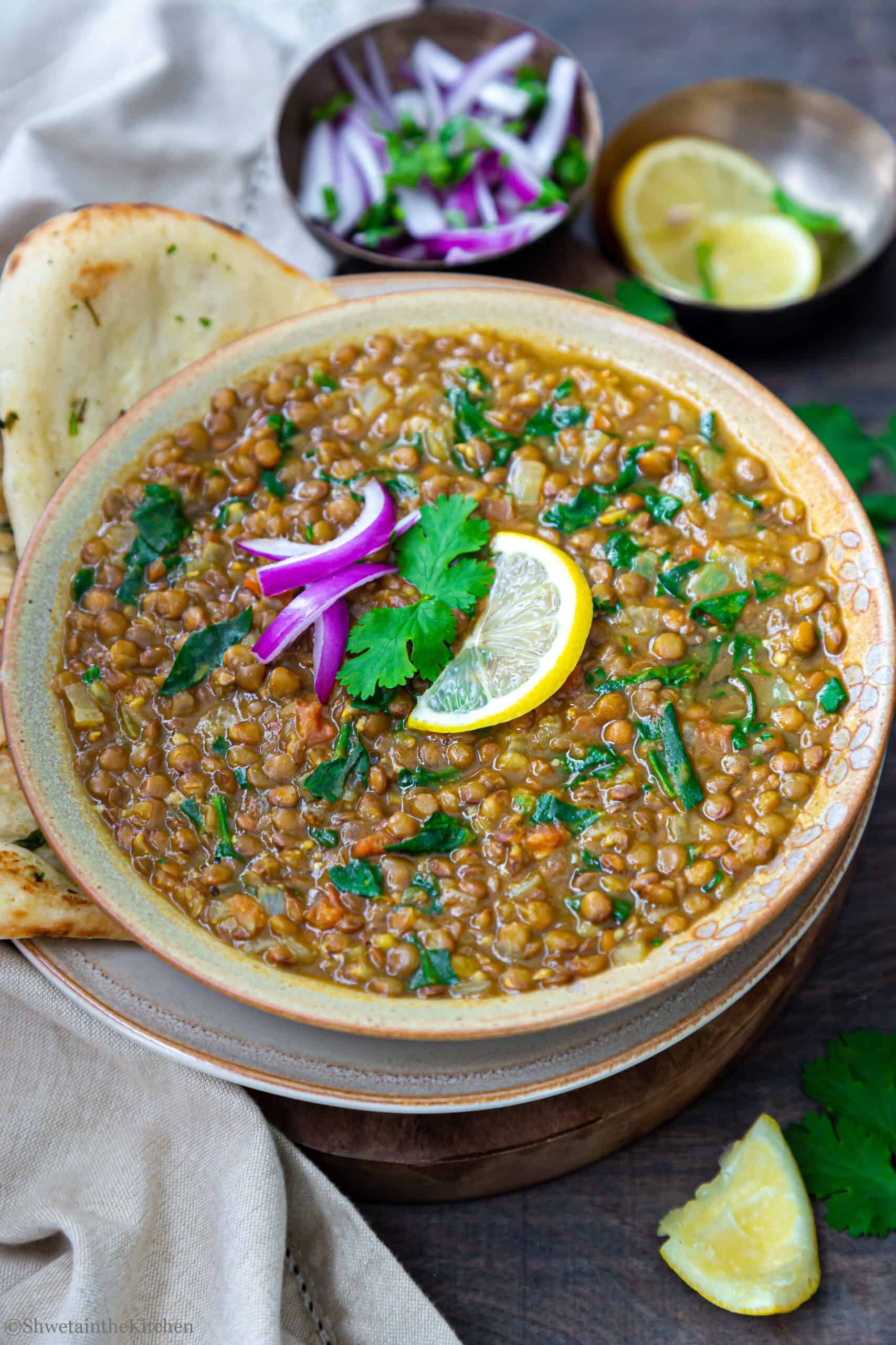 Side view of Whole Masoor Dal Palak in a bowl