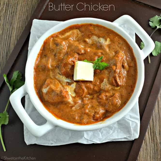 Top view of butter chicken in a white bowl