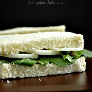 A cucumber sandwich on a black background with text overlay