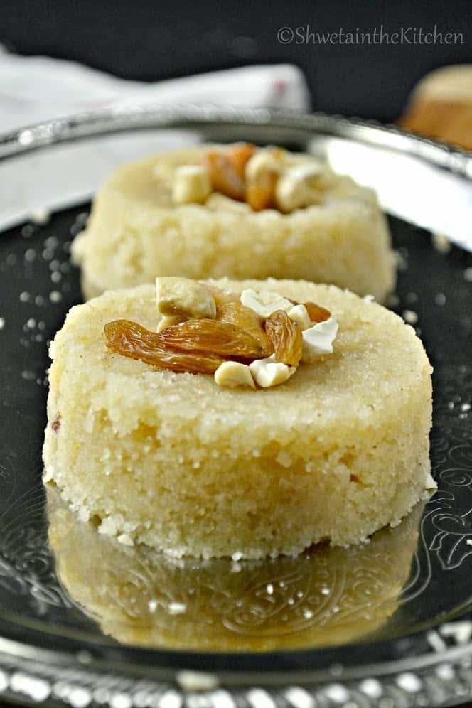 Rava sheera formed into two rounds and topped with nuts