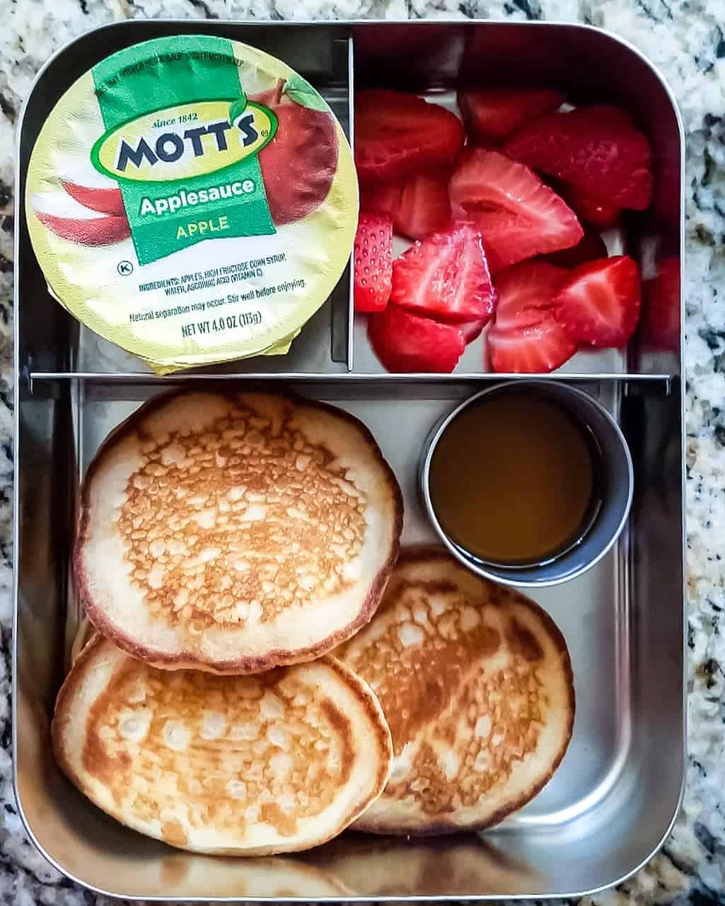 Eggless Pancakes with maple syrup, applesauce and sliced strawberries