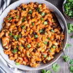 vegetarian taco pasta in a bowl garnished with cilantro and green onions