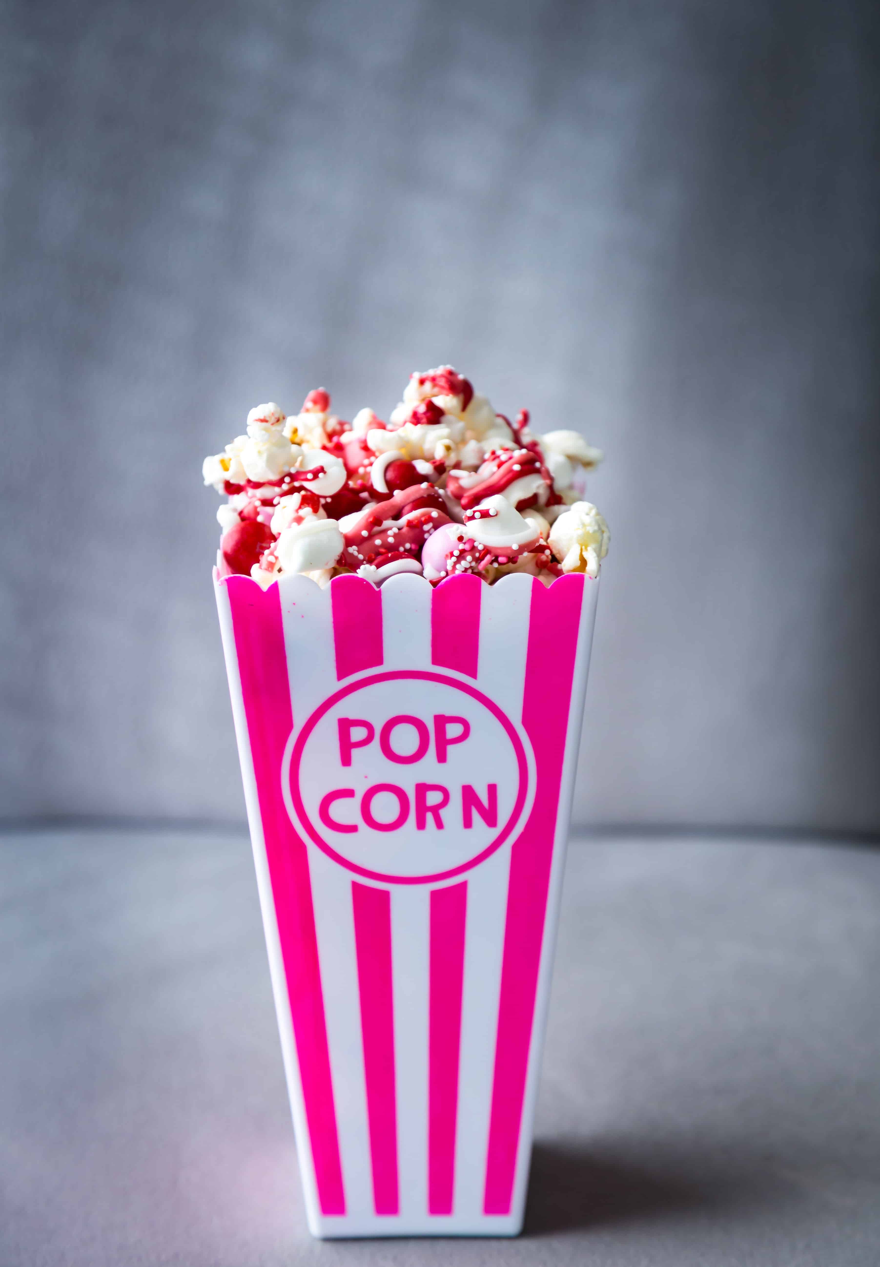 Chocolate Drizzled Popcorn in a pink popcorn container.