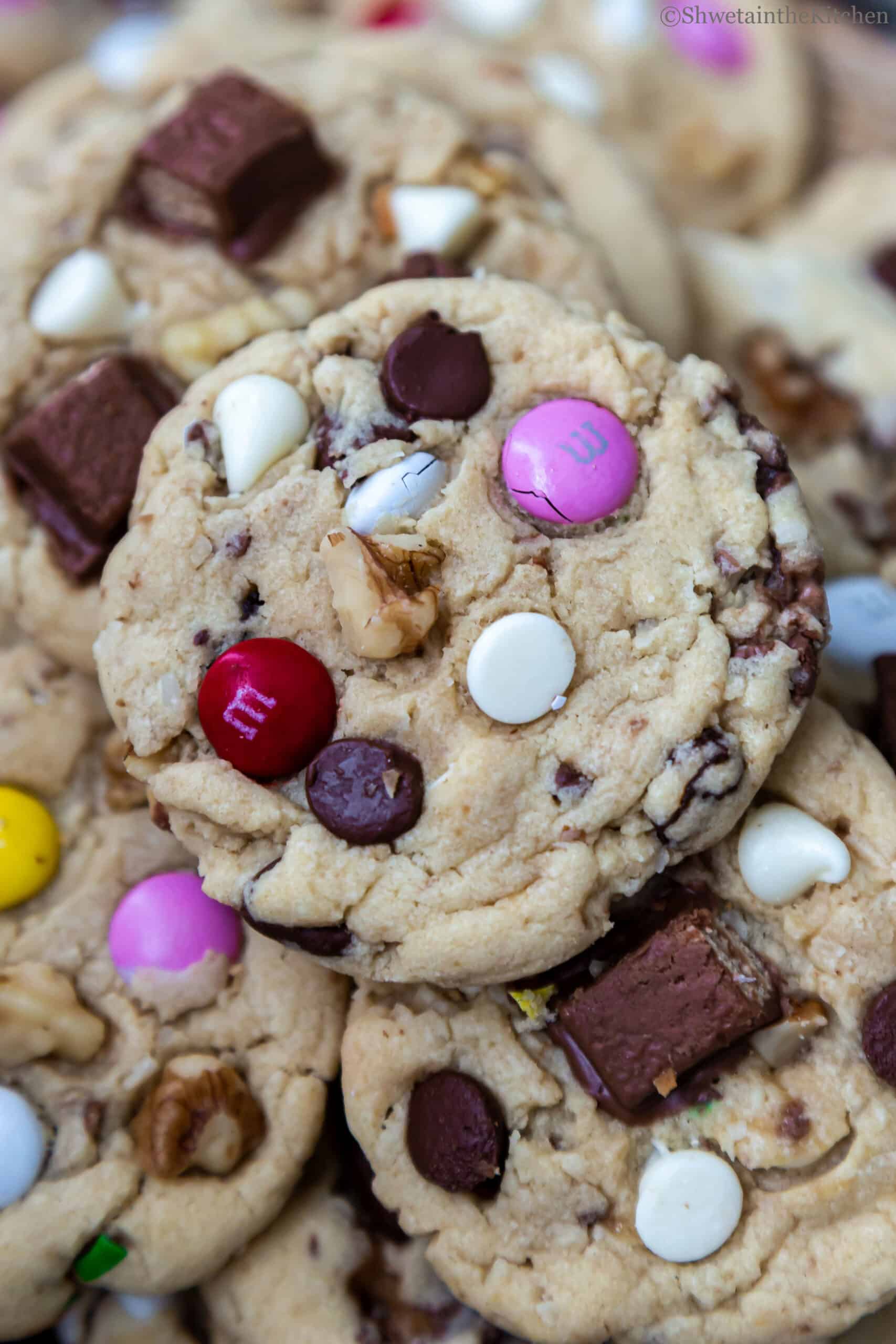 zoomed in view of Eggless Kitchen Sink Cookies showing chocolate chips, walnuts and M&M's