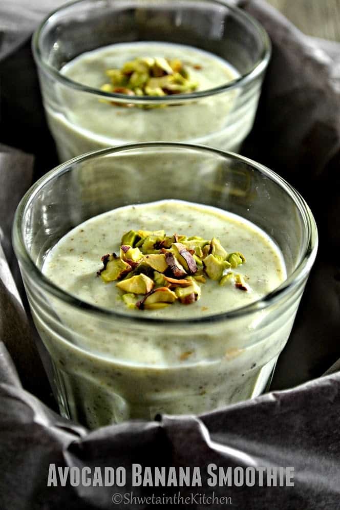 Close up of chopped pistachios on top of the avocado banana smoothie