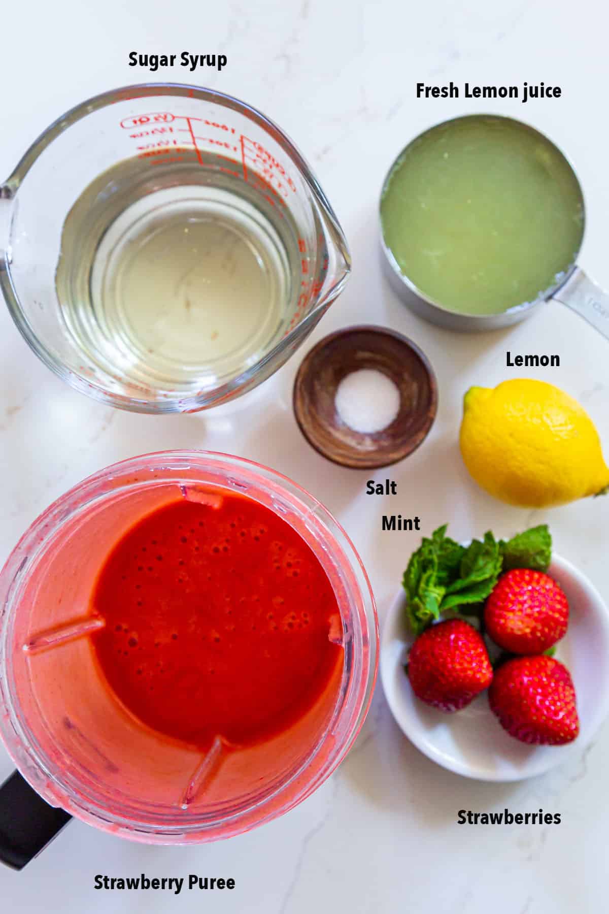 strawberry lemonade Ingredients placed in bowls and cups along with garnishes