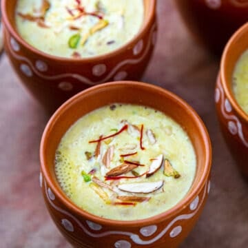 2 cups of masala milk garnished with nuts and saffron