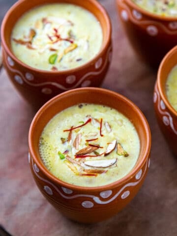 2 cups of masala milk garnished with nuts and saffron