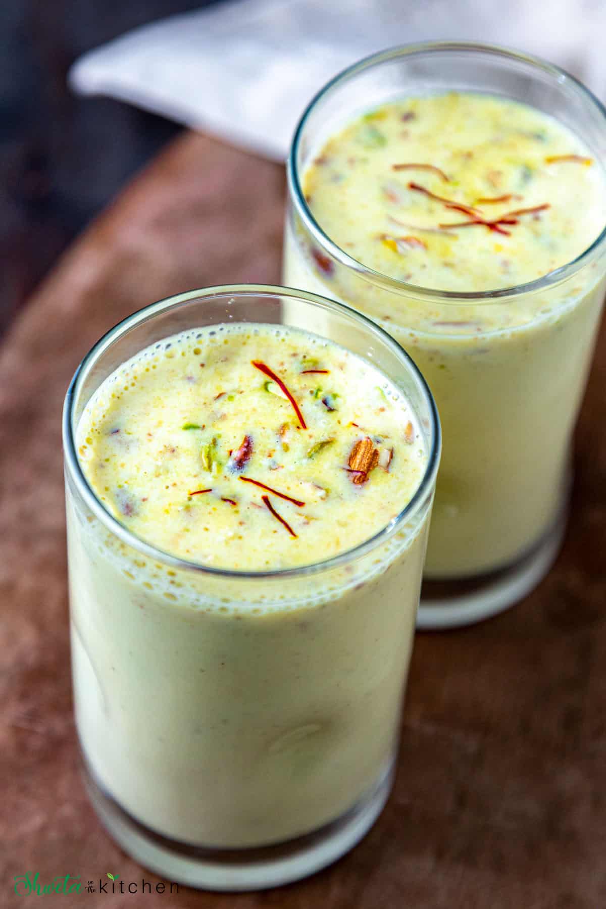 2 glasses of masala milk garnished with nuts