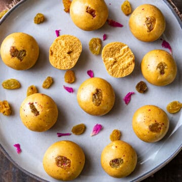 Besan ladoo on plate with one split open