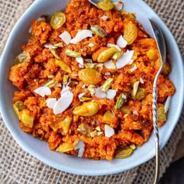 Carrot Halwa in a blue bowl with spoon