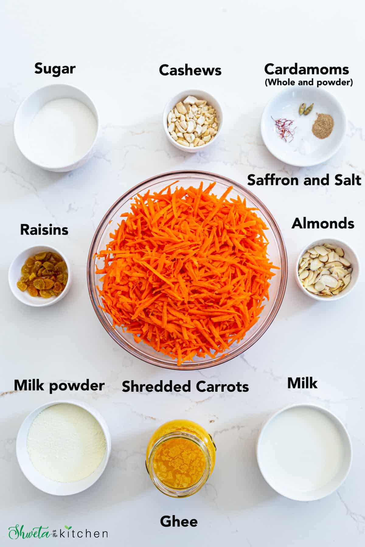 Gajar Halwa Ingredients in white bowls on white surface