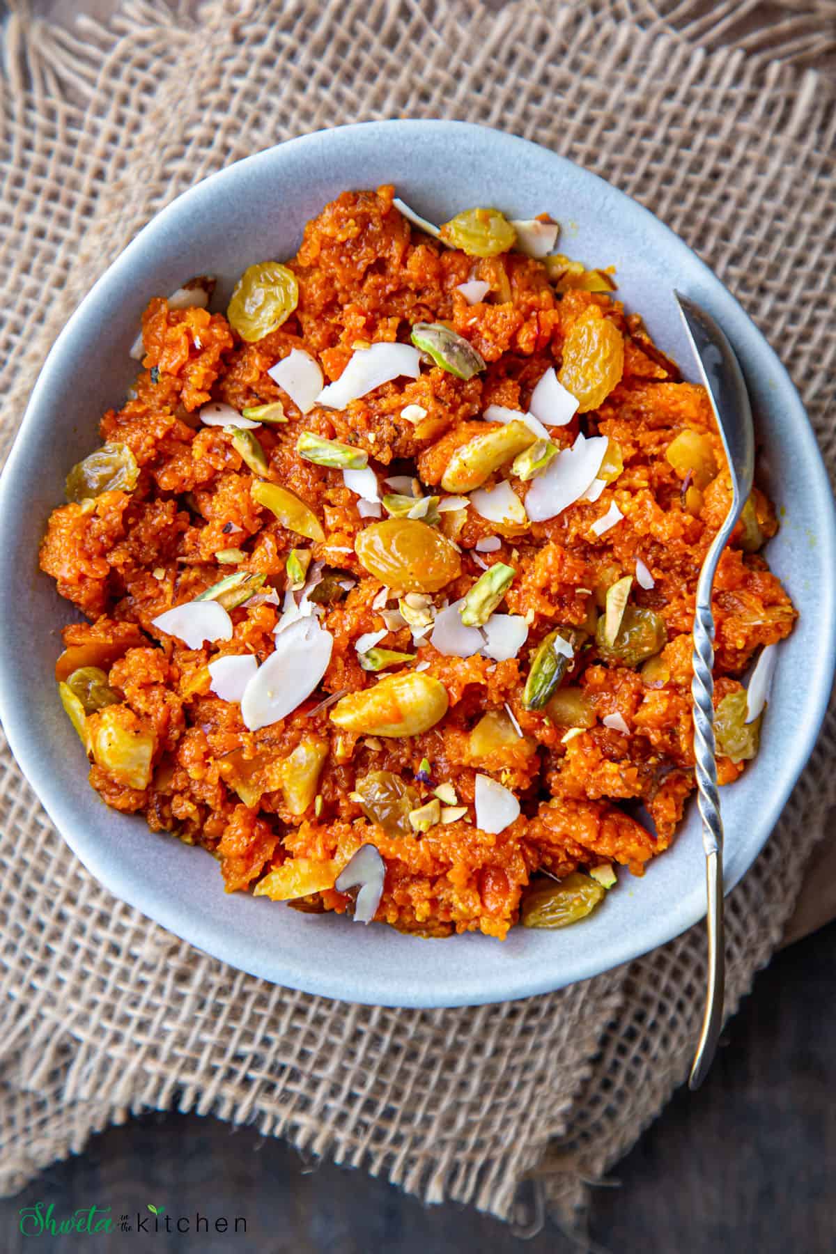 Carrot Halwa in a blue bowl with spoon