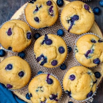 Top view of Eggless blueberry muffins on a round wooden board
