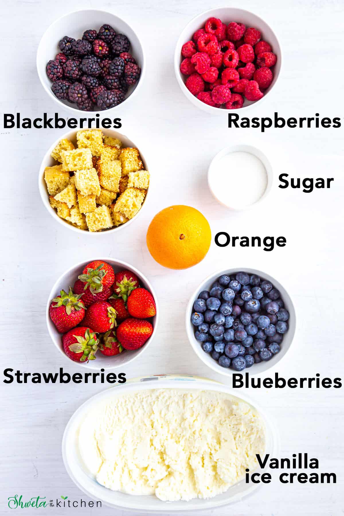 Ingredients for Berry Parfait on white surface in white bowls