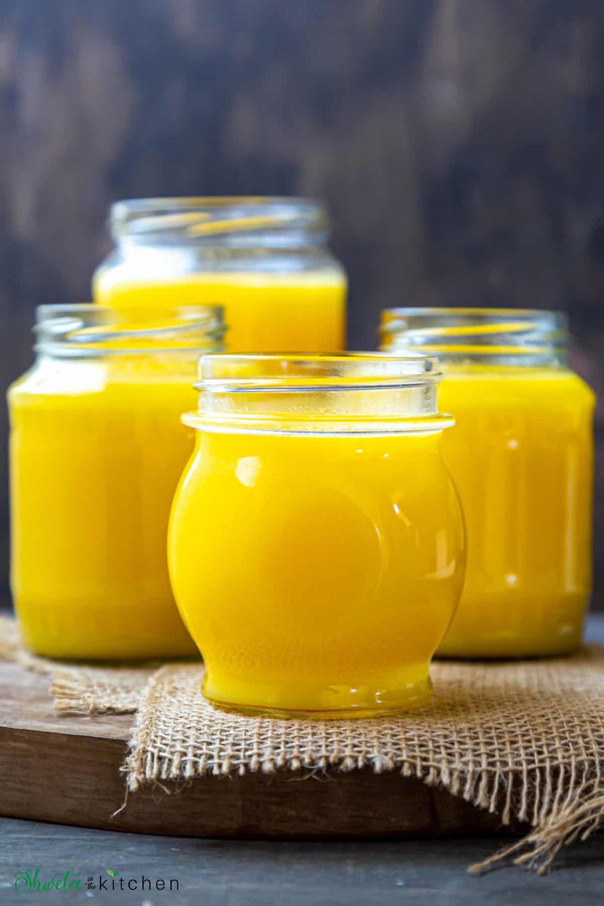 4 jars of bright yellow colored homemade ghee