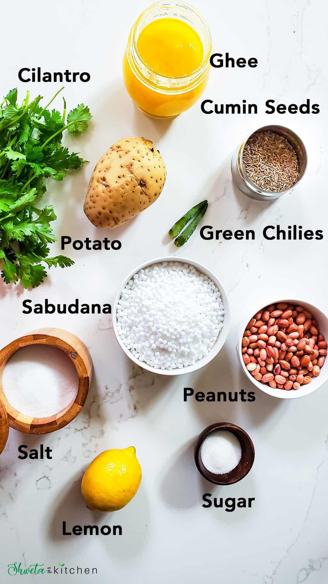 Ingredients for Sabudana Khichdi on a white marble surface