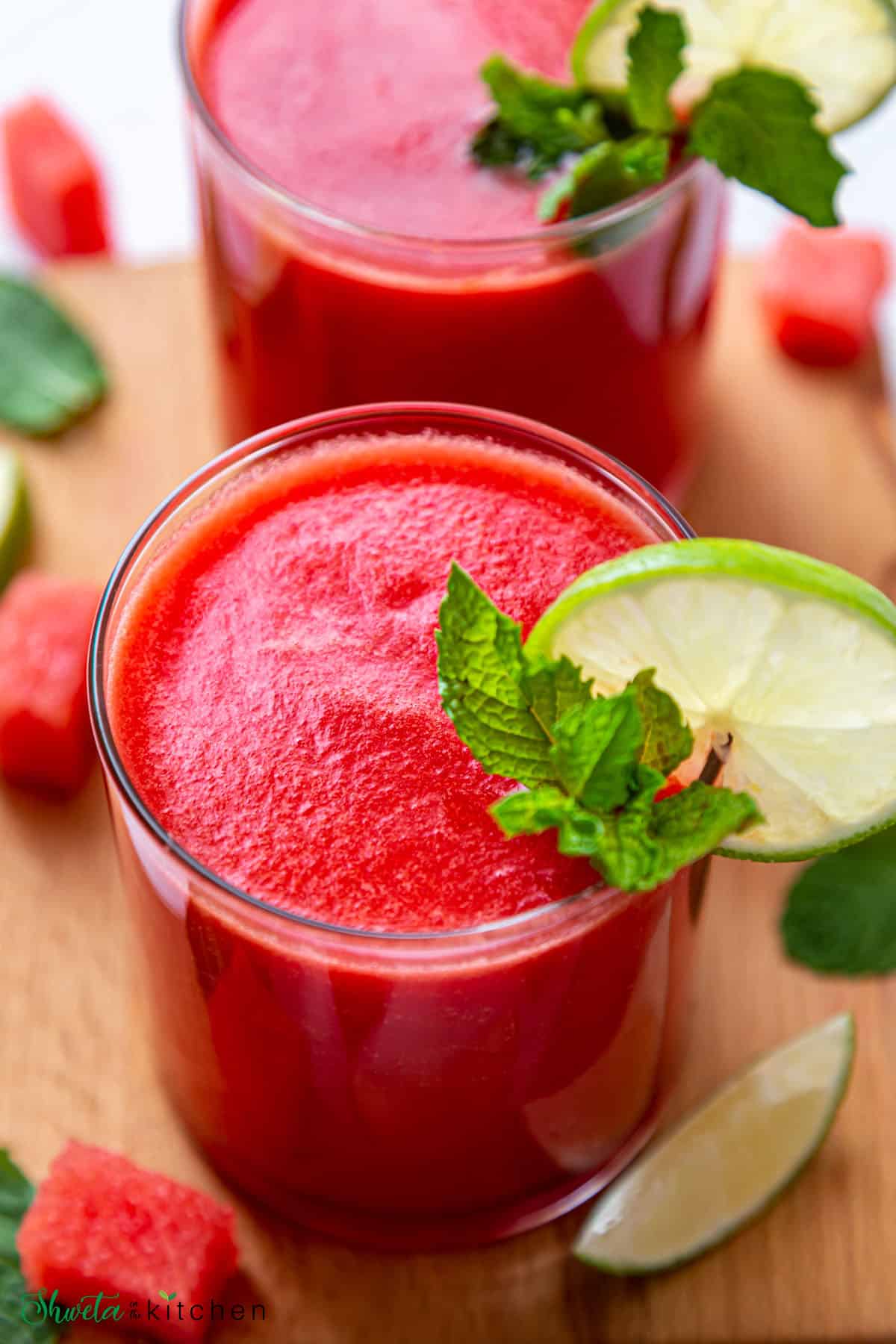 Two glasses of easy and best watermelon juice garnished with lemon slice and mint leaves