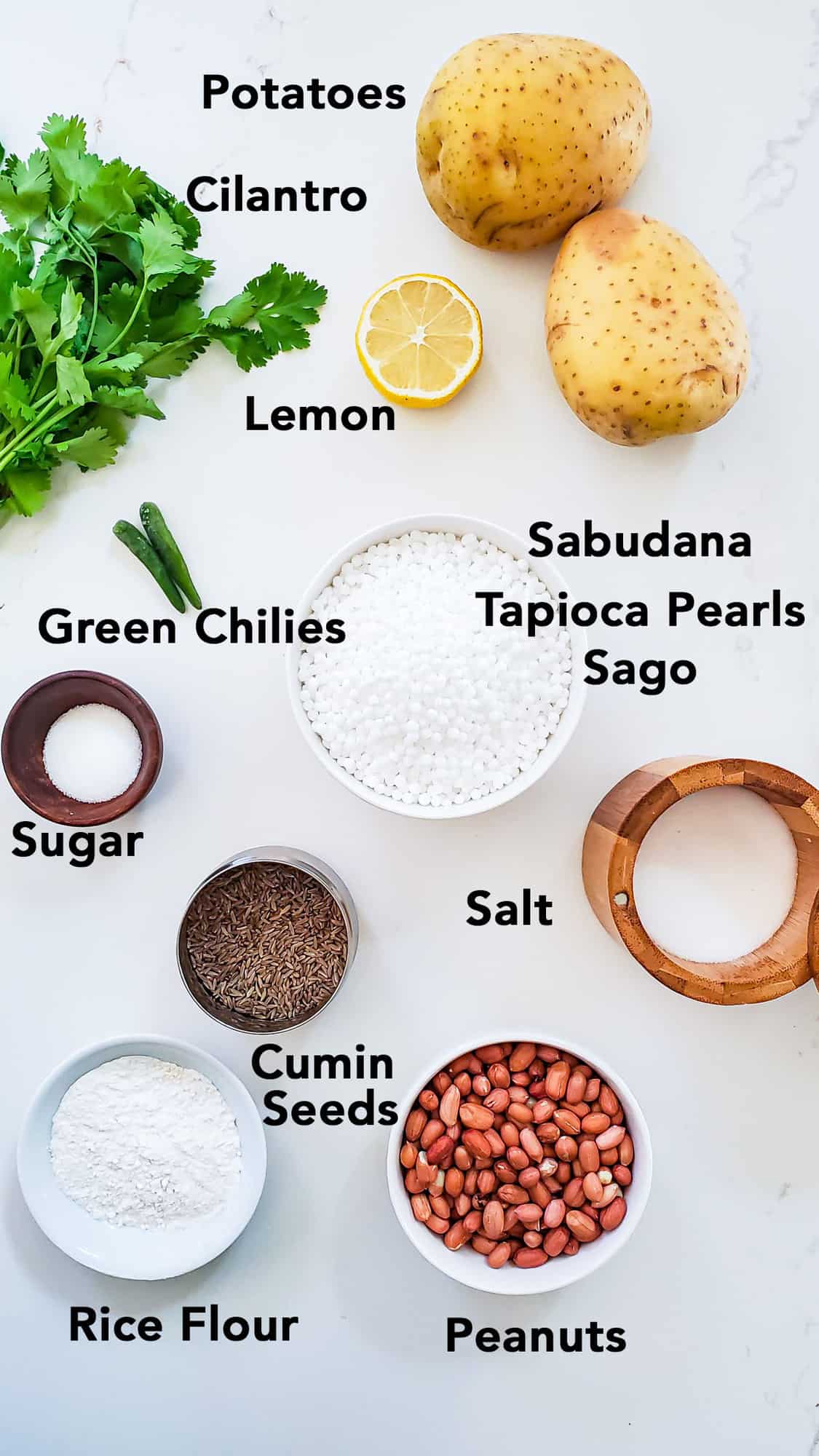 Sabudana Vada Ingredients in bowls on white surface