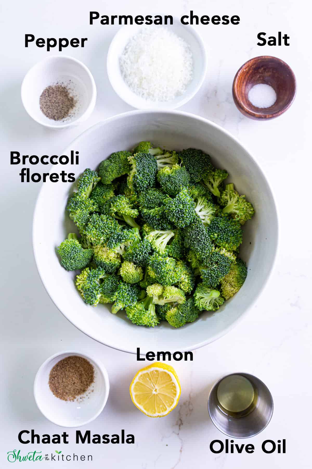 Air fryer broccoli ingredients in white bowls on white surface