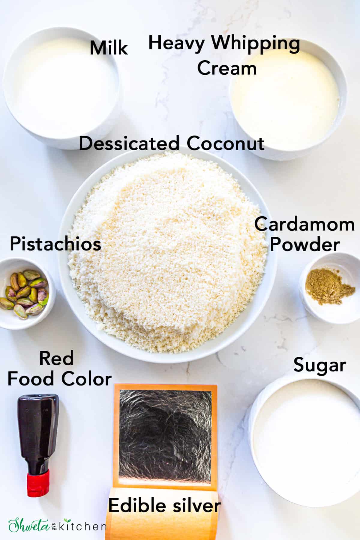 Coconut Burfi ingredients placed in bowls on white surface