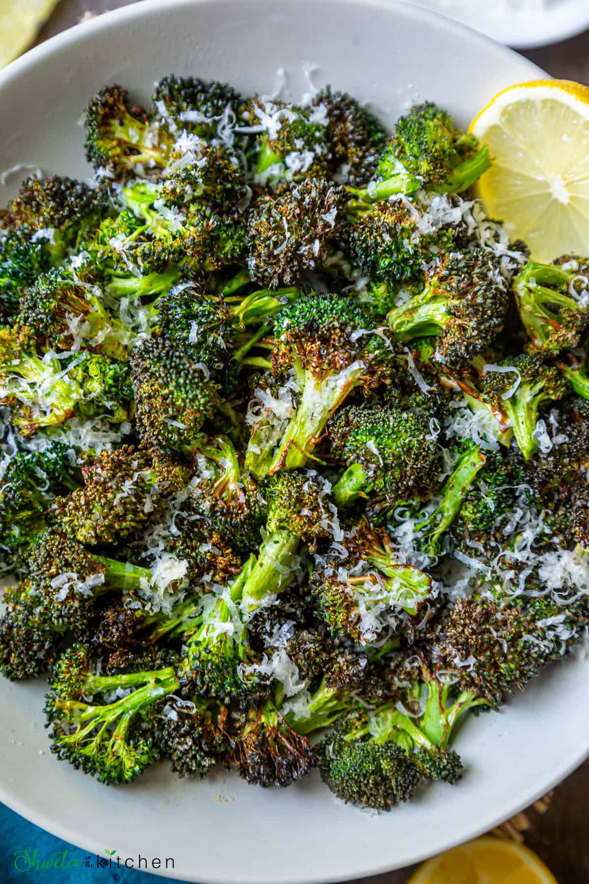 Close up shot of air fryer roasted broccoli on a plate 