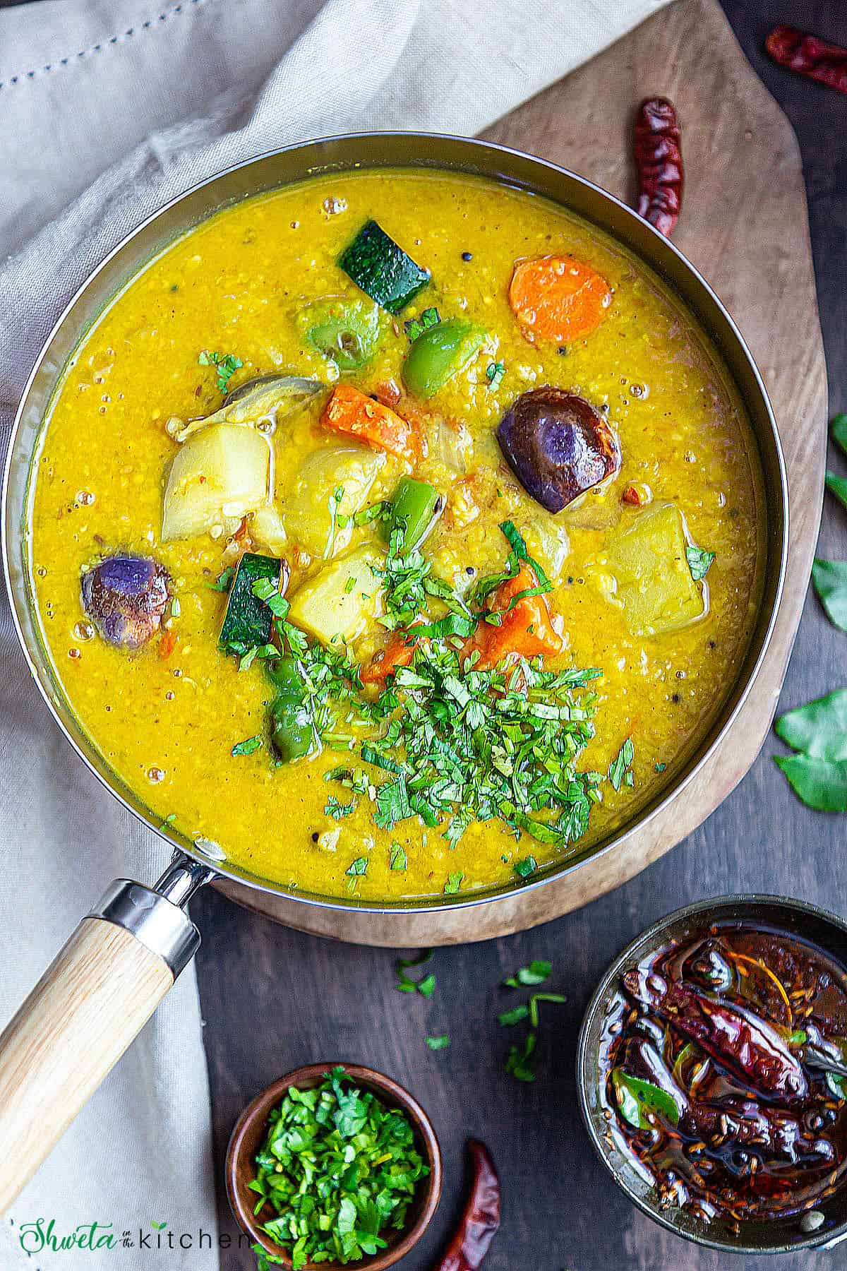 Easy one pot sambar in a pan with tempering on the side along with cilantro