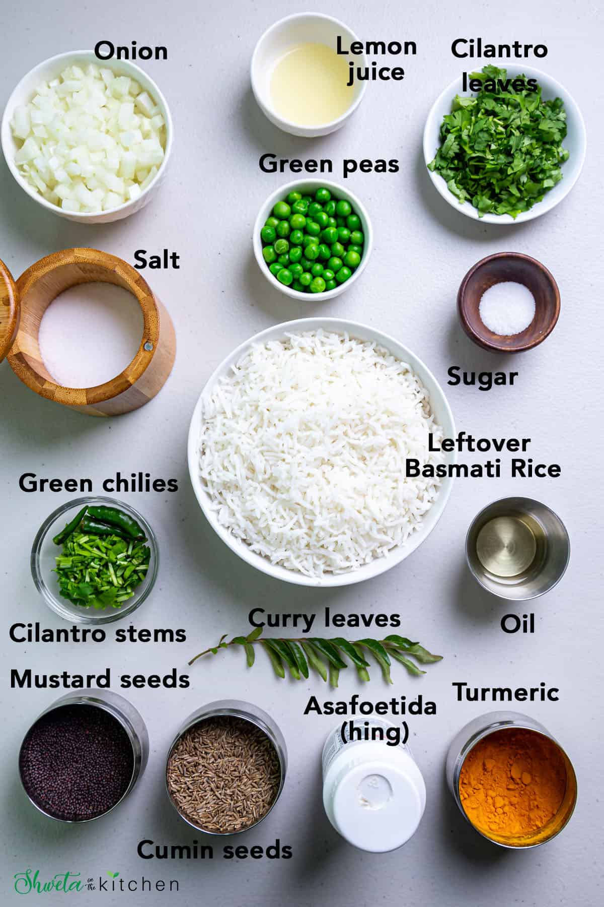 Ingredients for phodnicha bhaat in bowls on white surface