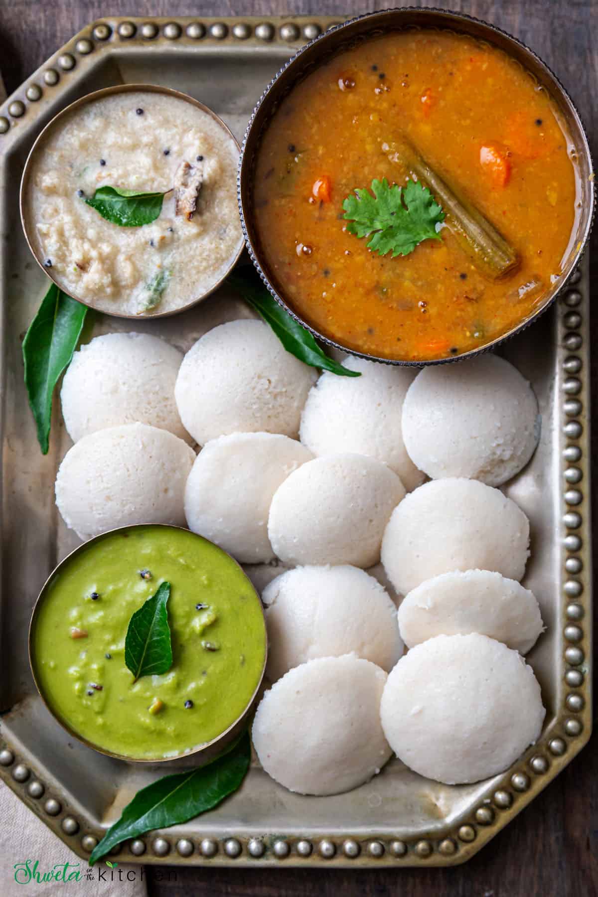 hotel style soft idli sambar chutney on a rectangle tray