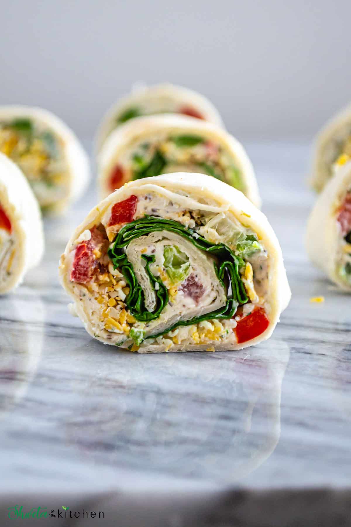 Vegetarian Tortilla pinwheels cut into slices showing the colorful filling