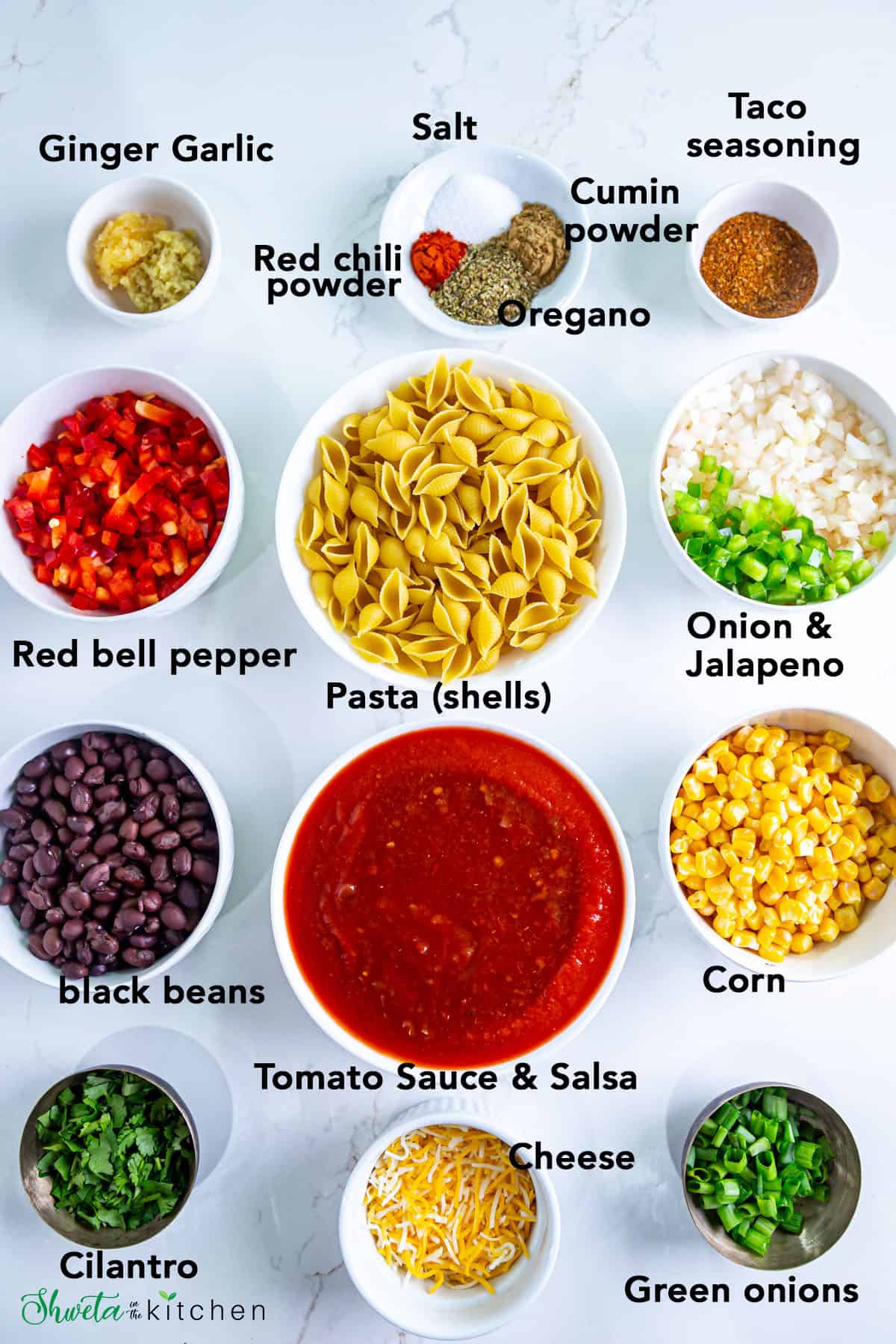 Ingredients for vegetarian Instant pot taco pasta arranged in bowls on white surface