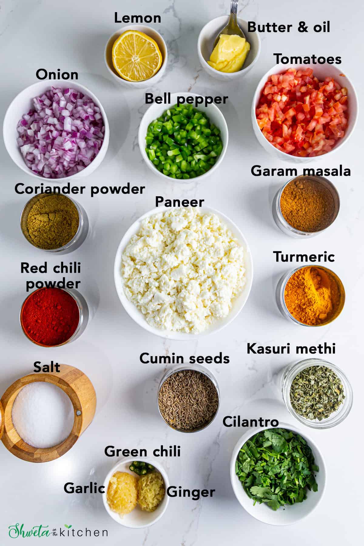 Ingredients for paneer bhurji arranged in bowls on white surface