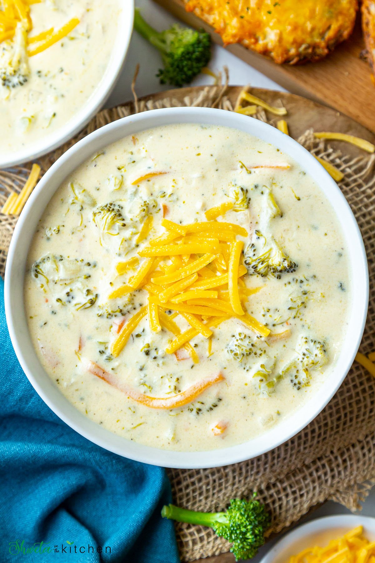 Instant pot broccoli cheddar soup in a bowl topped with cheese