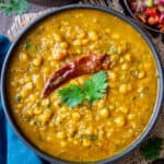 Chana dal served in a black bowl and garnished with fresh cilantro