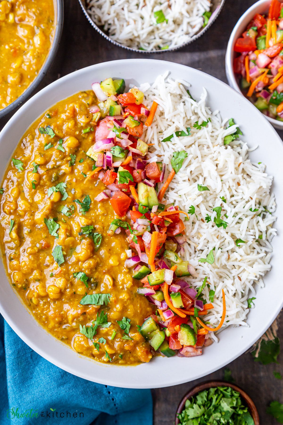 Chana dal served with rice on a plate with kachumber salad