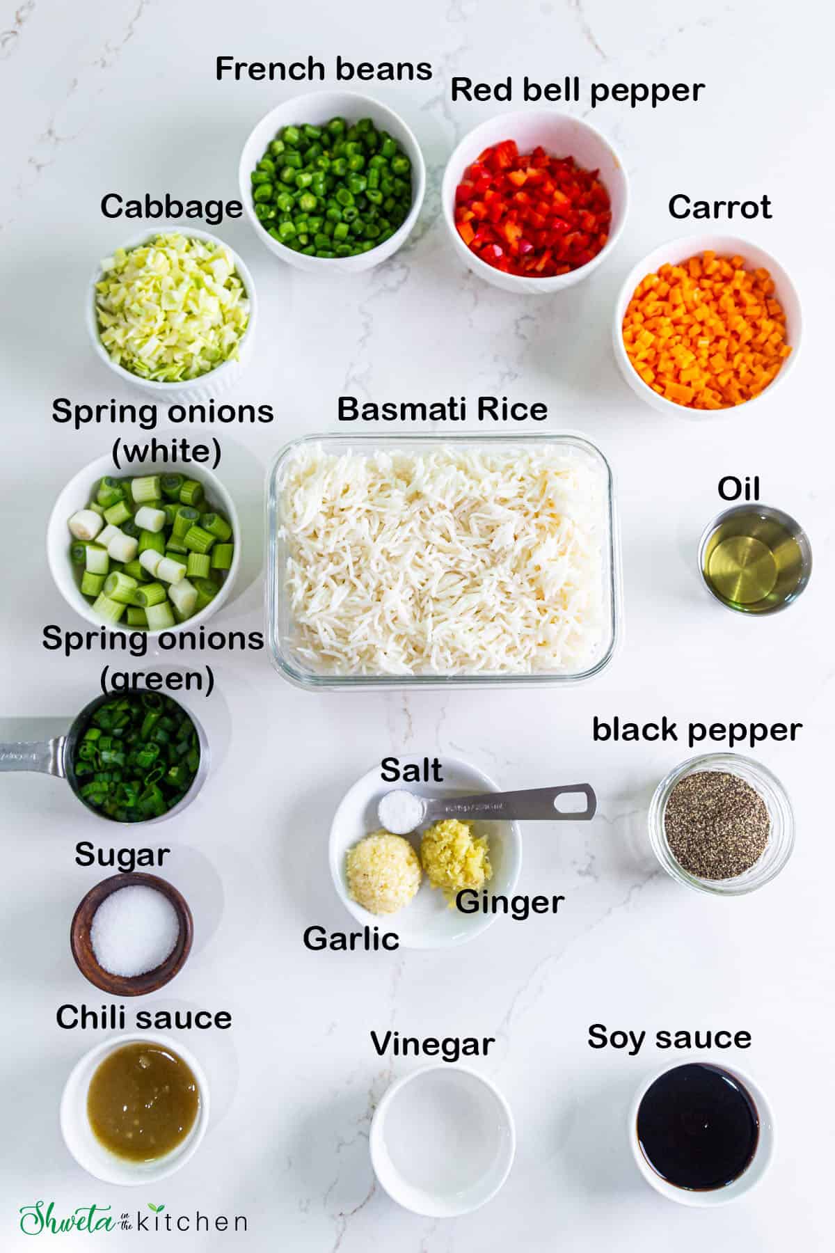 Ingredients for veg fried rice placed in a bowls on white surface