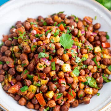 Top view of a bowl full of kala chana chaat (black chickpea salad)