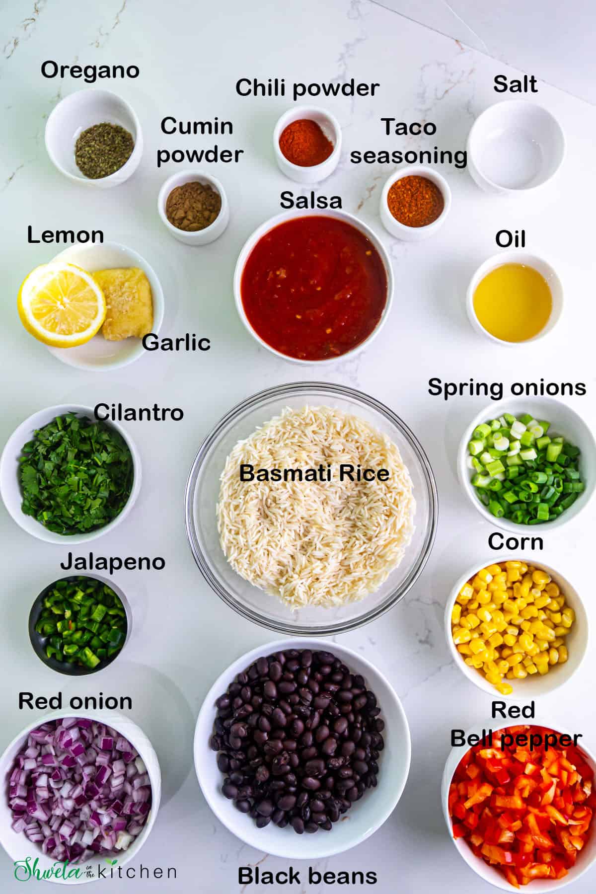 Ingredients for Instant Pot Mexican Rice and Beans in white bowls on white surface
