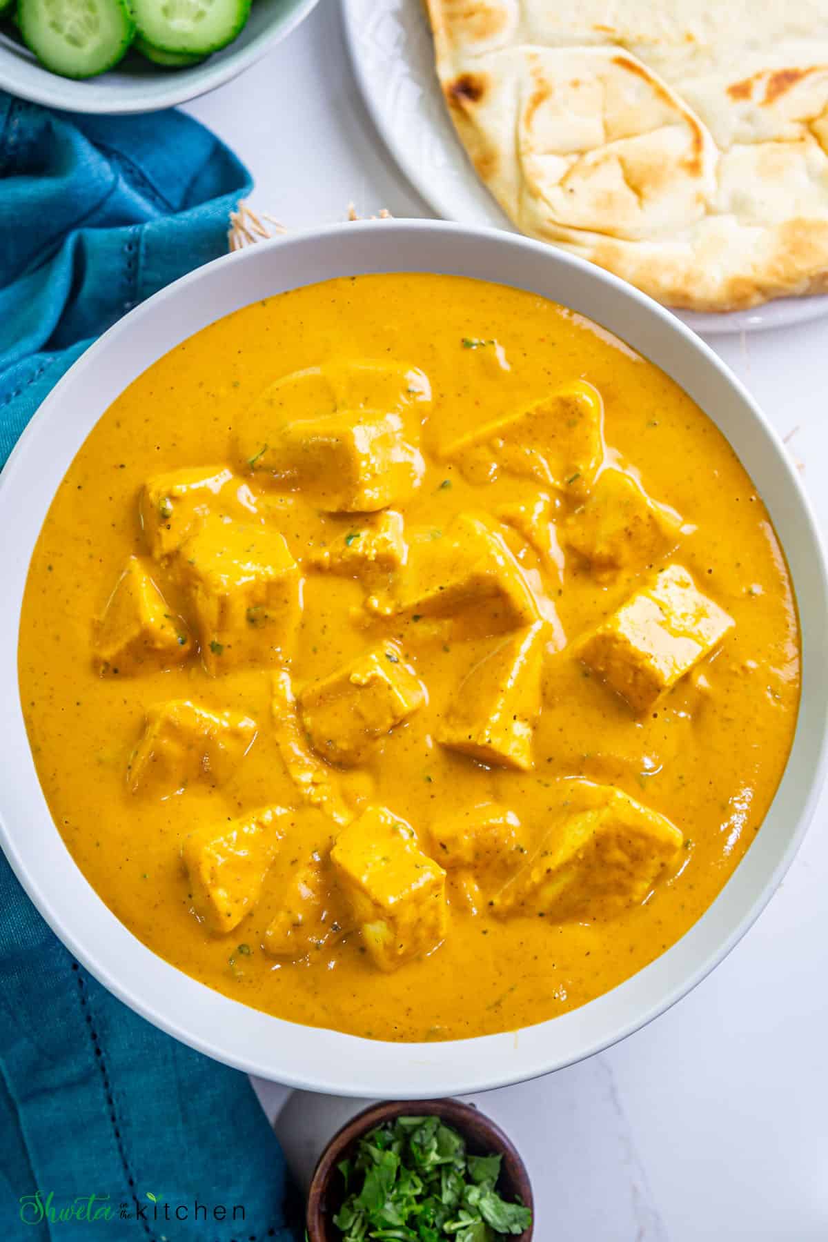 Top view of shahi paneer placed in a bowl with no garnish