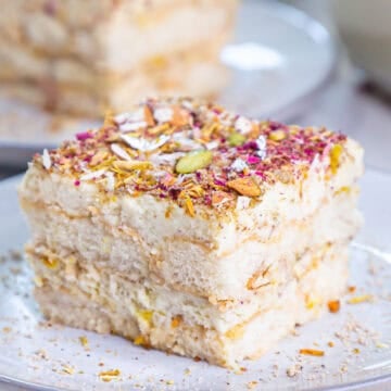 Slice of thandai tiramisu place sideways on a plate