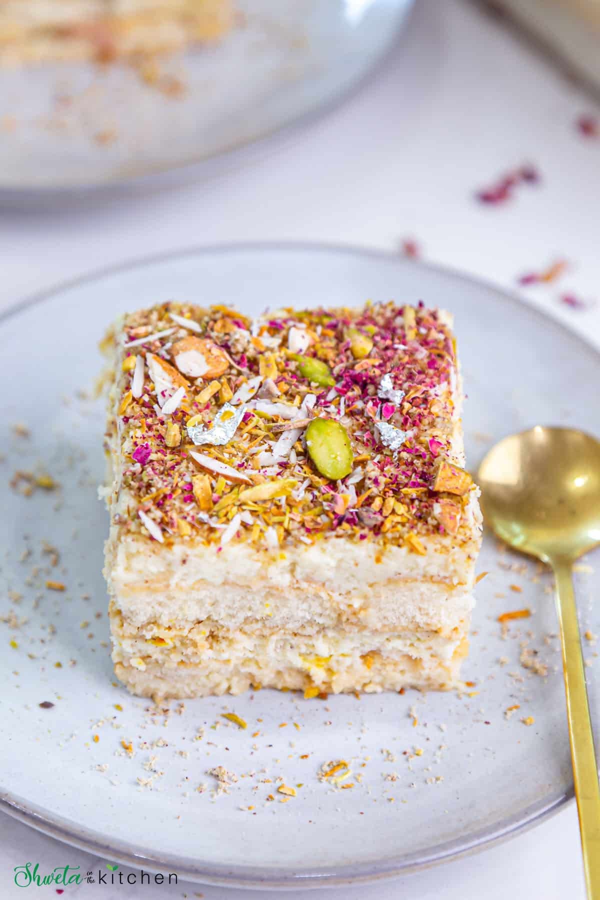 Top angled view of thandai tiramisu slice showing the garnish and layer