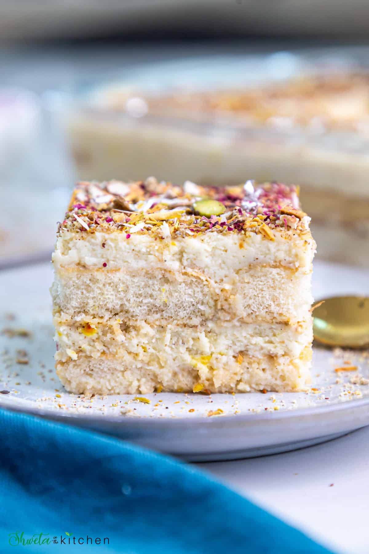 Side view of slice of thandai tiramisu showing the cream and layfinger layers